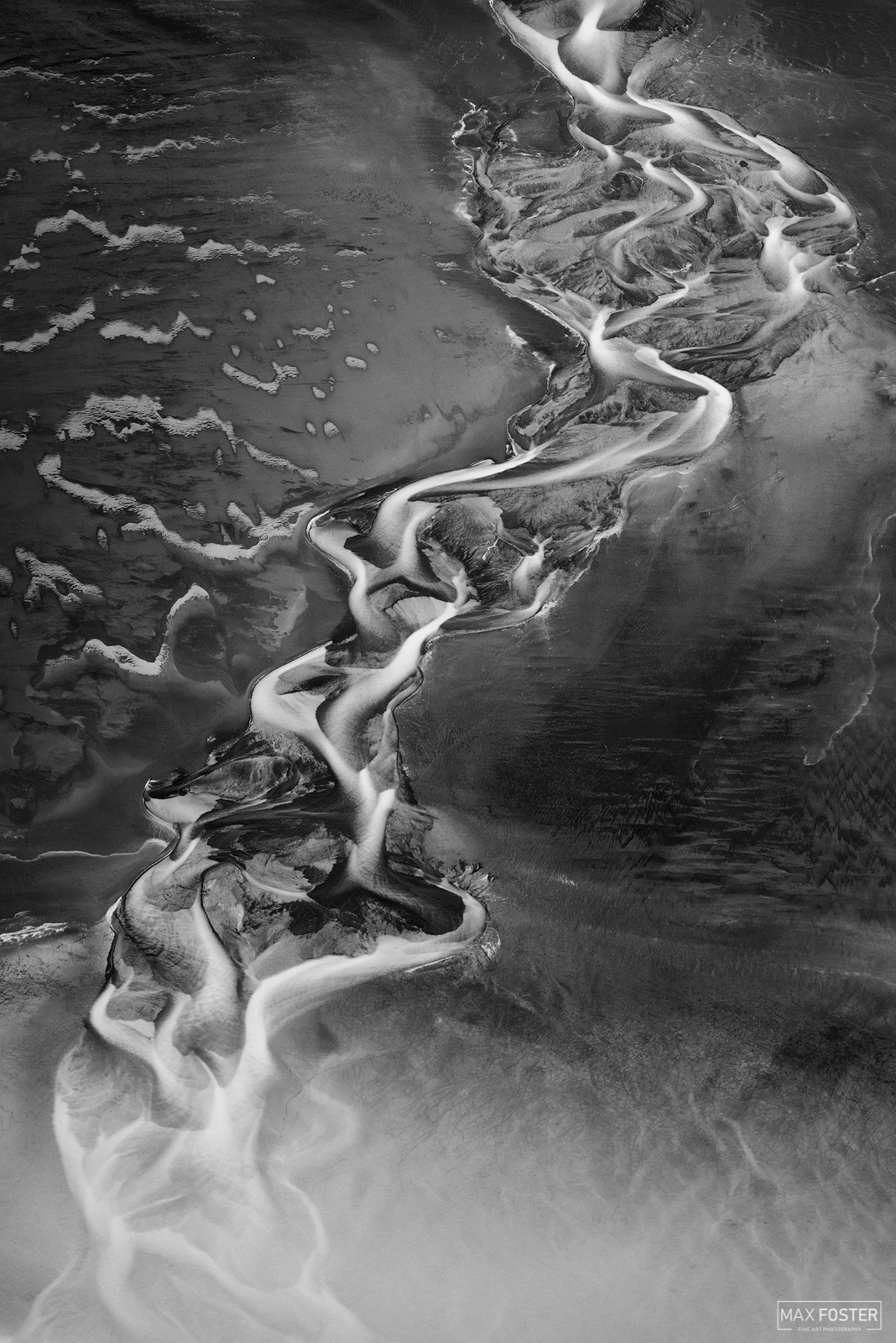 Elevate your space with Eternal Flame Monochrome, Max Foster's limited edition aerial photography print of a river in Iceland...